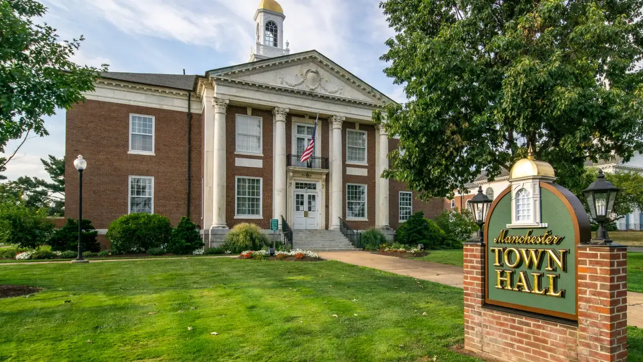 Manchester Town Hall, a brick Georgian building with a gold-domed cupola, in Manchester, Connecticut